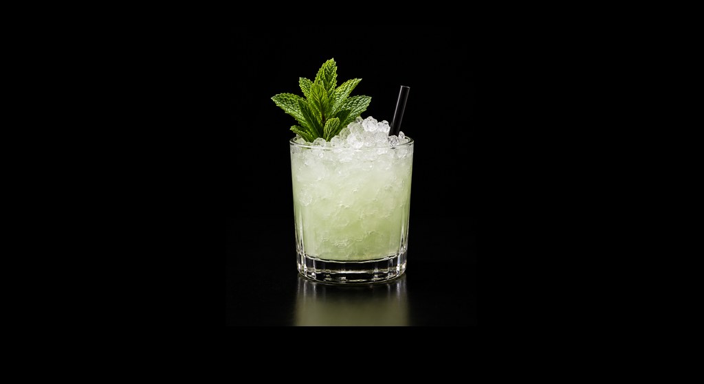Absinthe Frappé cocktail on a dark studio background