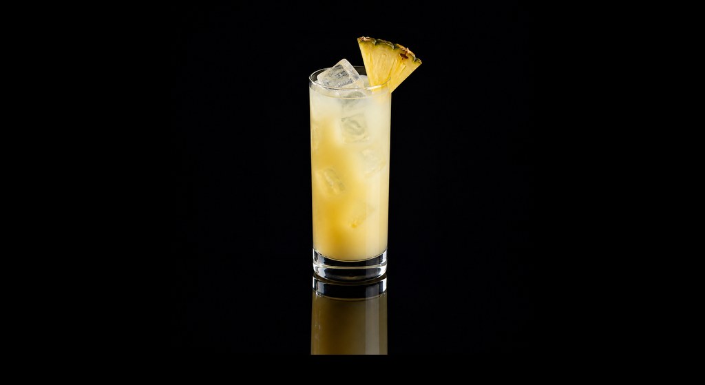 Almond Pina Colada cocktail on a dark studio background