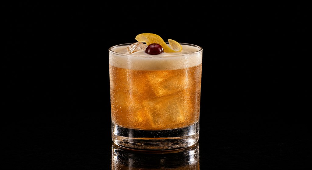 Amaretto Sour cocktail on a black background