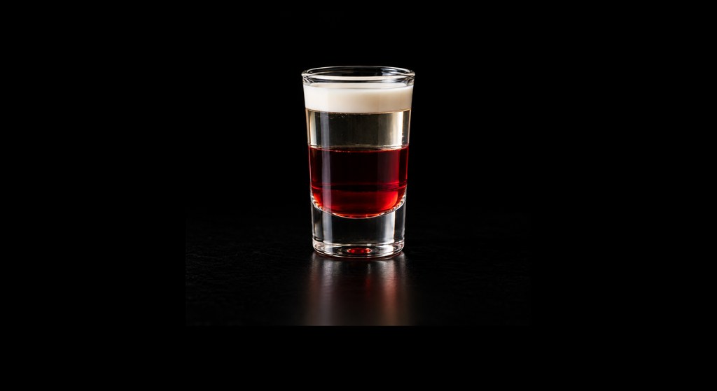 Angel's Delight cocktail on a dark studio background