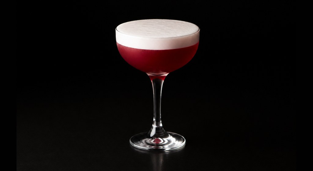 Angostura Sour cocktail on a dark studio background