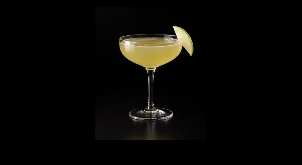 Apple Grass cocktail on a dark studio background
