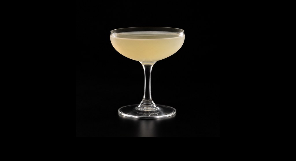 Apple Jack (by Sasha Petraske) cocktail on a dark studio background