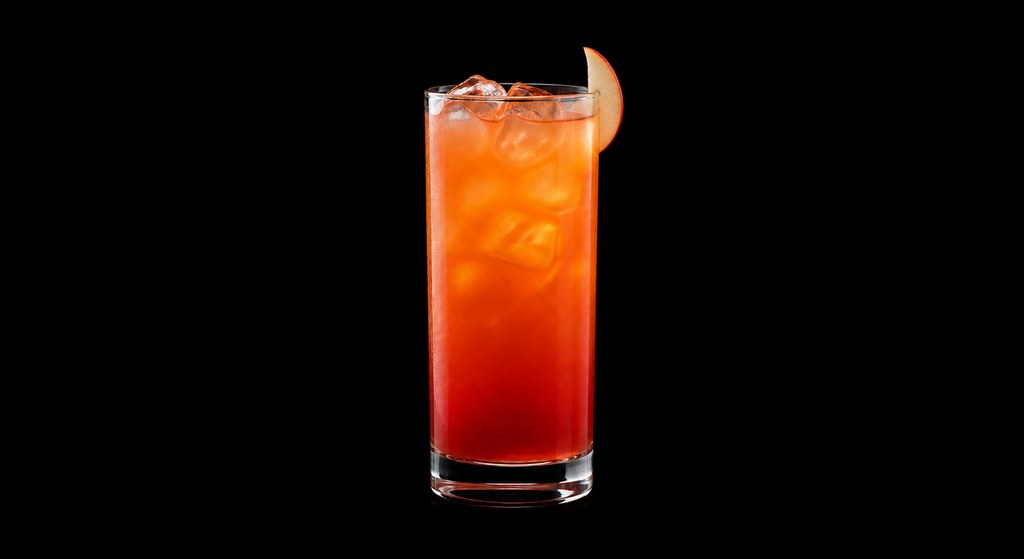 Apple Sunrise cocktail on a dark studio background