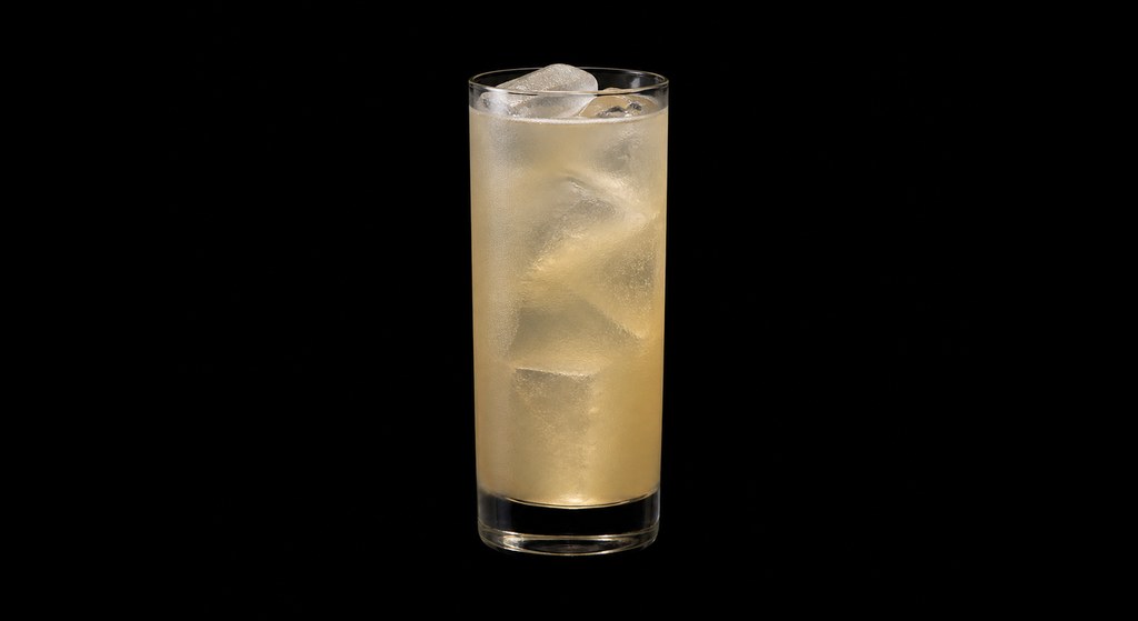 Apricot Anise Collins cocktail on a dark studio background