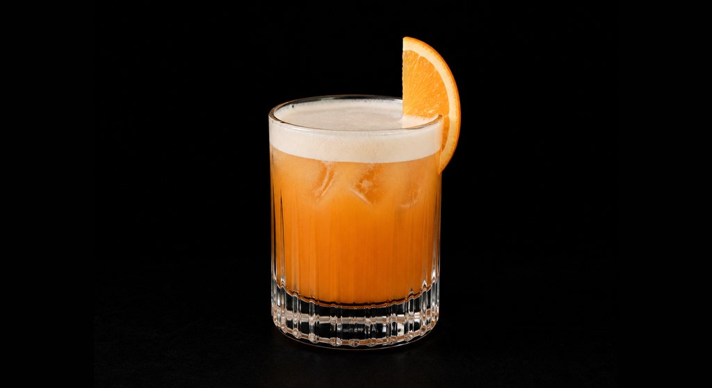 Apricot Lady cocktail on a dark studio background
