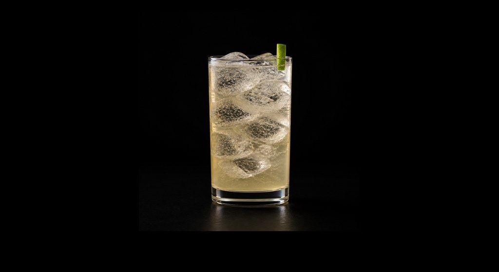 Apricot Rickey cocktail on a dark studio background