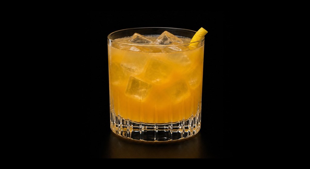 Apricot Sour cocktail on a dark studio background