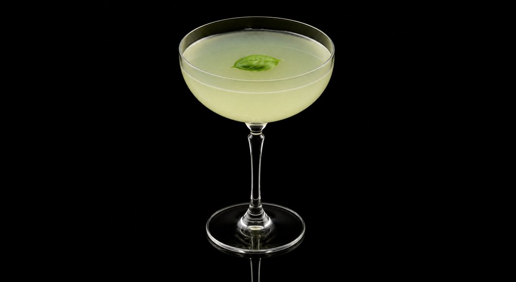 Basil Gimlet cocktail on a dark studio background
