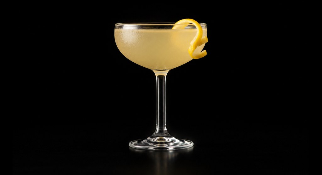 Bee's Knees cocktail on a dark studio background