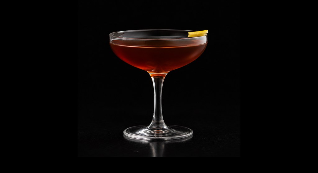 Beginning of the End cocktail on a dark studio background