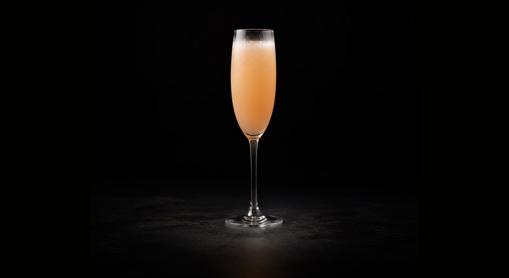 Bellini cocktail on a dark studio background