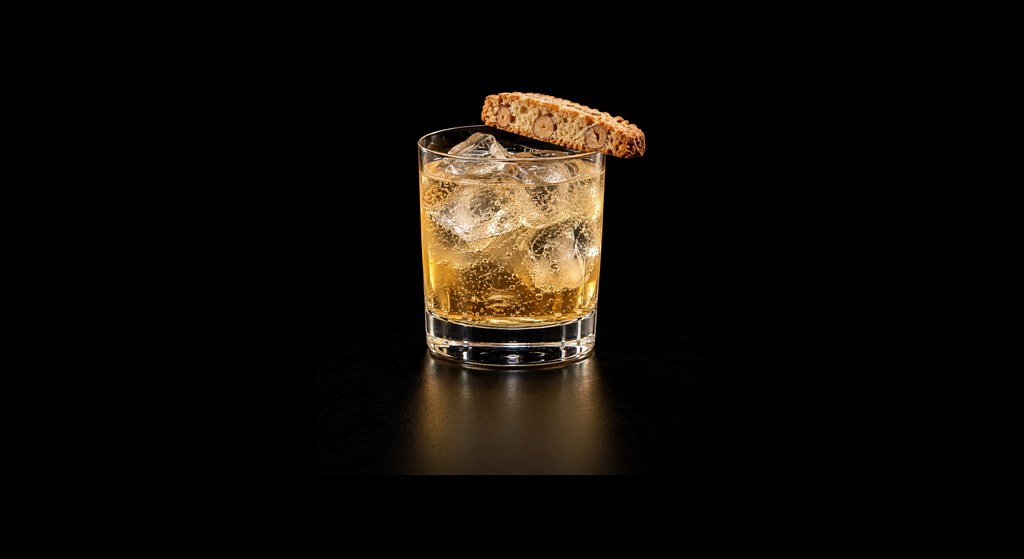 Biscotti Spritz cocktail on a dark studio background