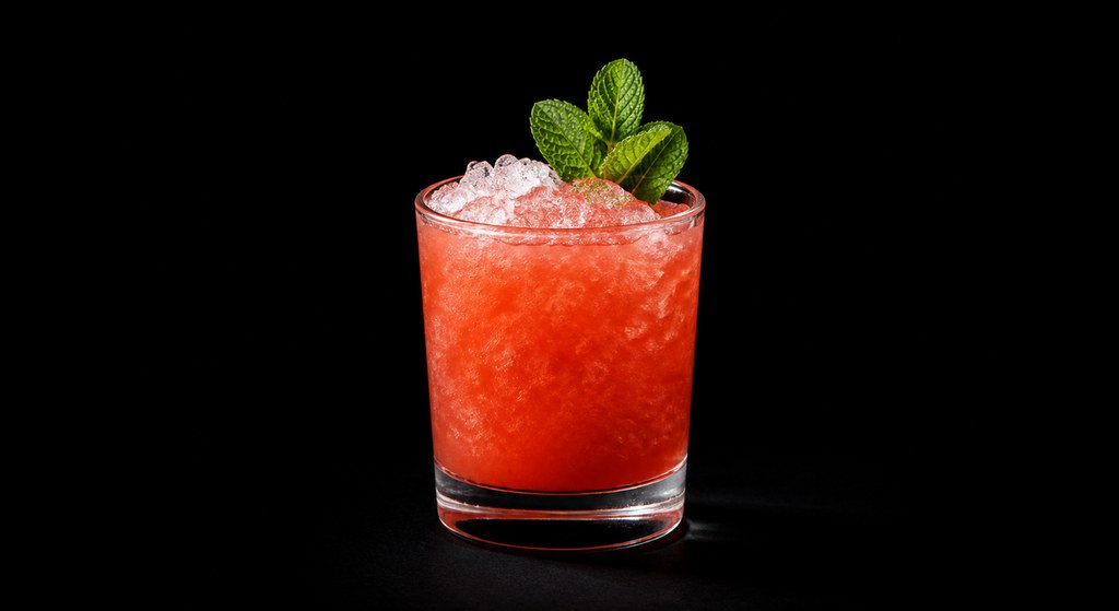 Bitter Mai Tai cocktail on a dark studio background