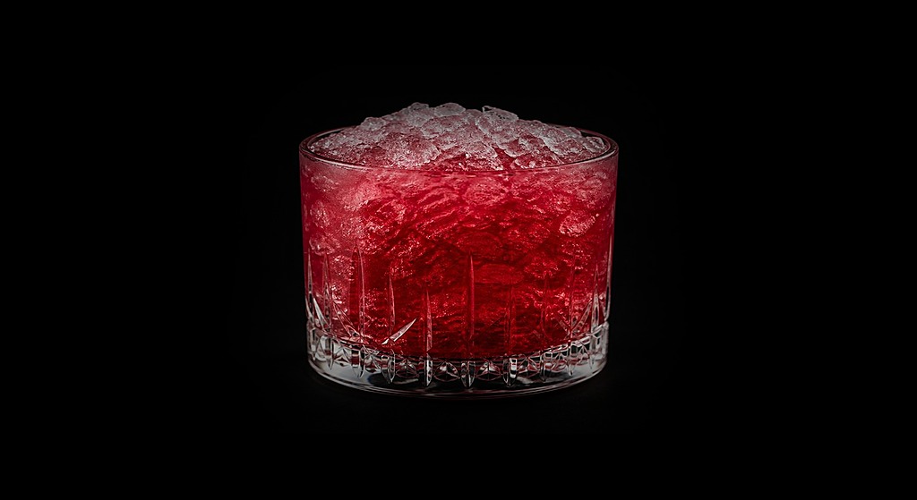 Bolshoi Punch cocktail on a dark studio background