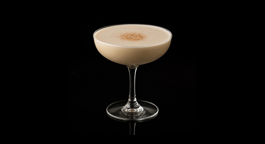 Bourbon Alexander cocktail on a dark studio background