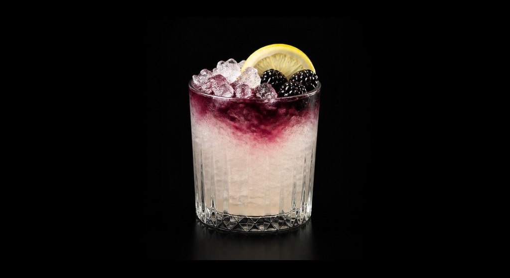 Bramble cocktail on a dark studio background