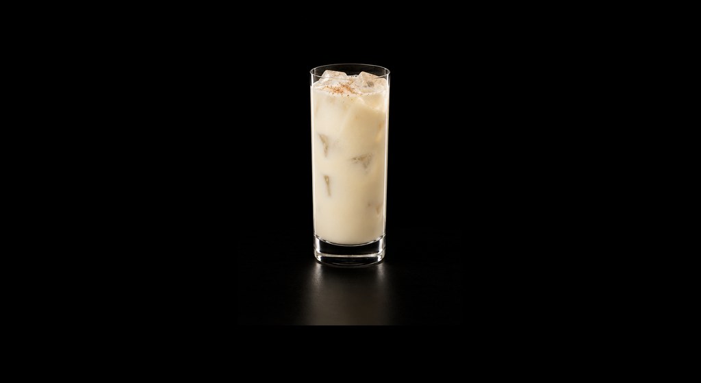 Brandy Milk Punch cocktail on a dark studio background