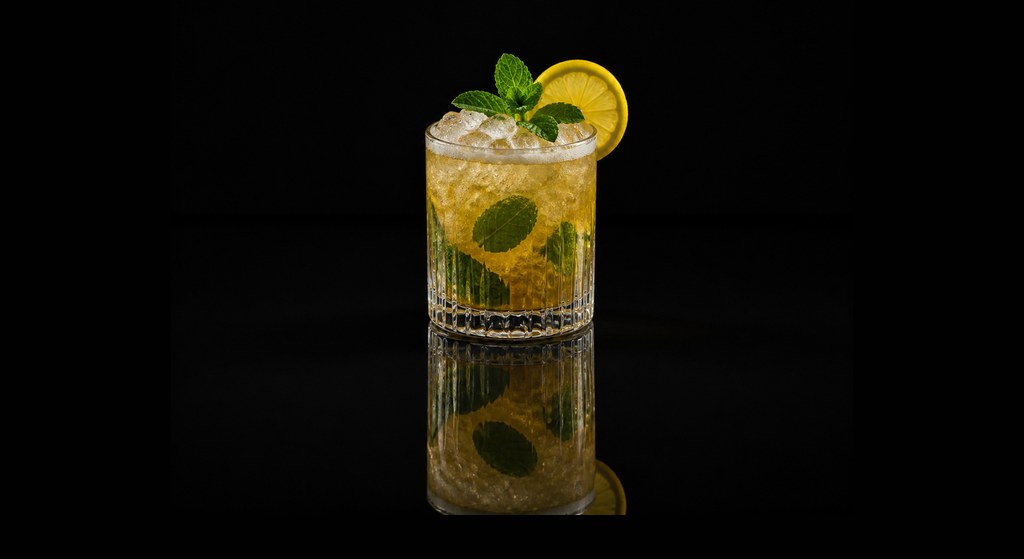 Brandy Smash cocktail on a dark studio background