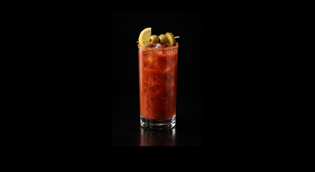 Buckfast Bloody Maìri cocktail on a dark studio background