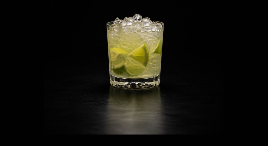 Caipirinha cocktail on a dark studio background
