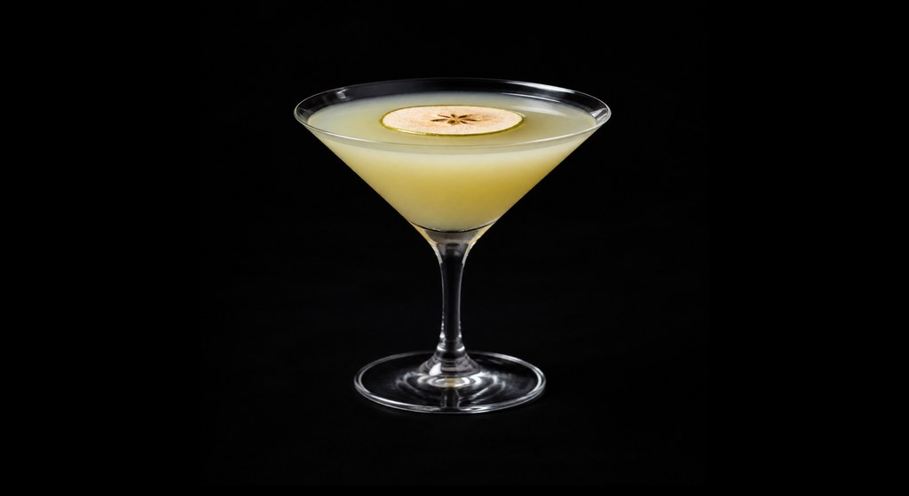 Calvados Appletini cocktail on a dark studio background
