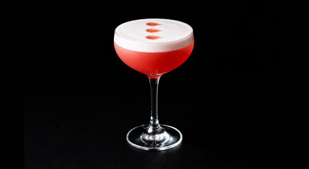 Campari Sour cocktail on a dark studio background