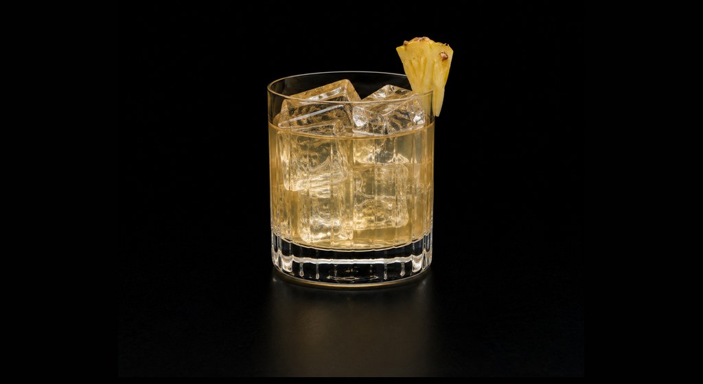 Canadian Pineapple cocktail on a dark studio background
