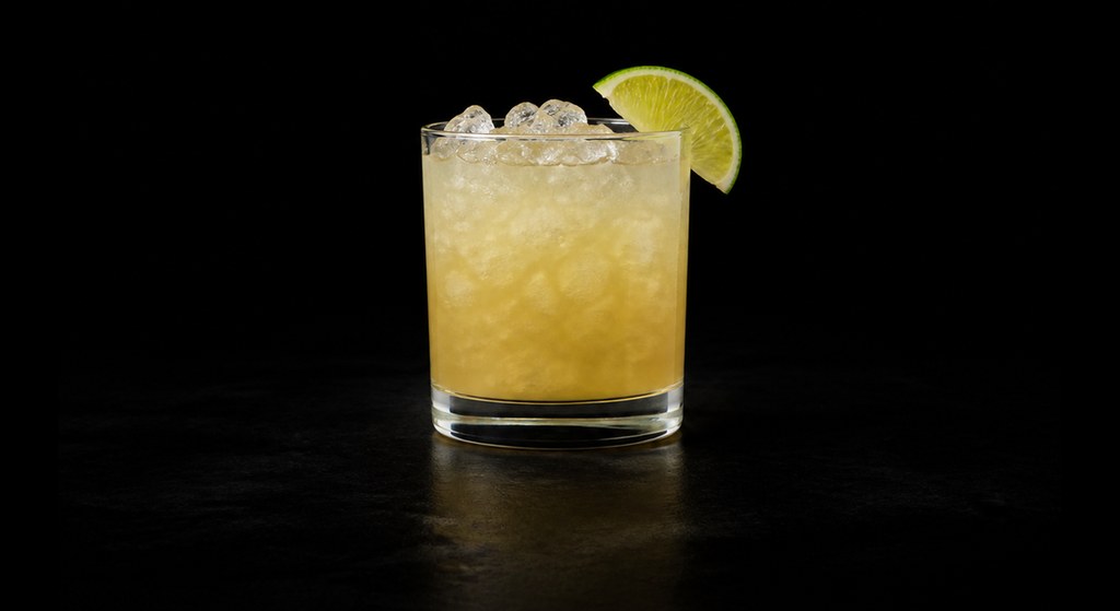 Canchánchara cocktail on a dark studio background