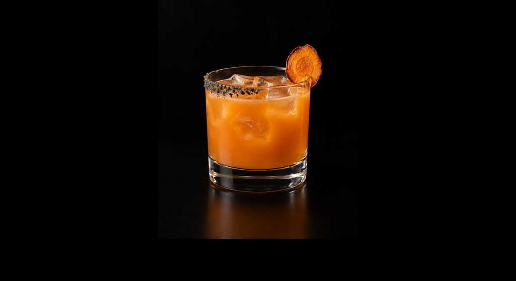 Carrot Thing cocktail on a dark studio background