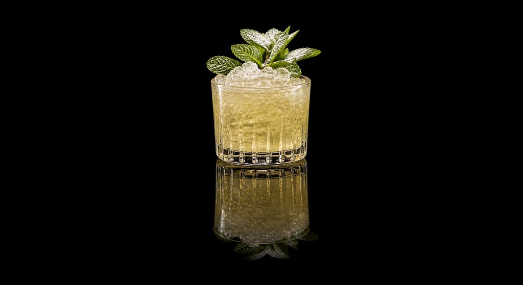 Champagne Julep cocktail on a dark studio background