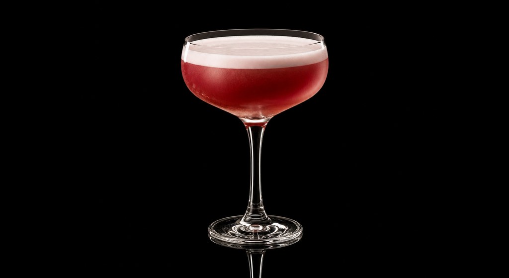 Cherry Bourbon Sour cocktail on a dark studio background