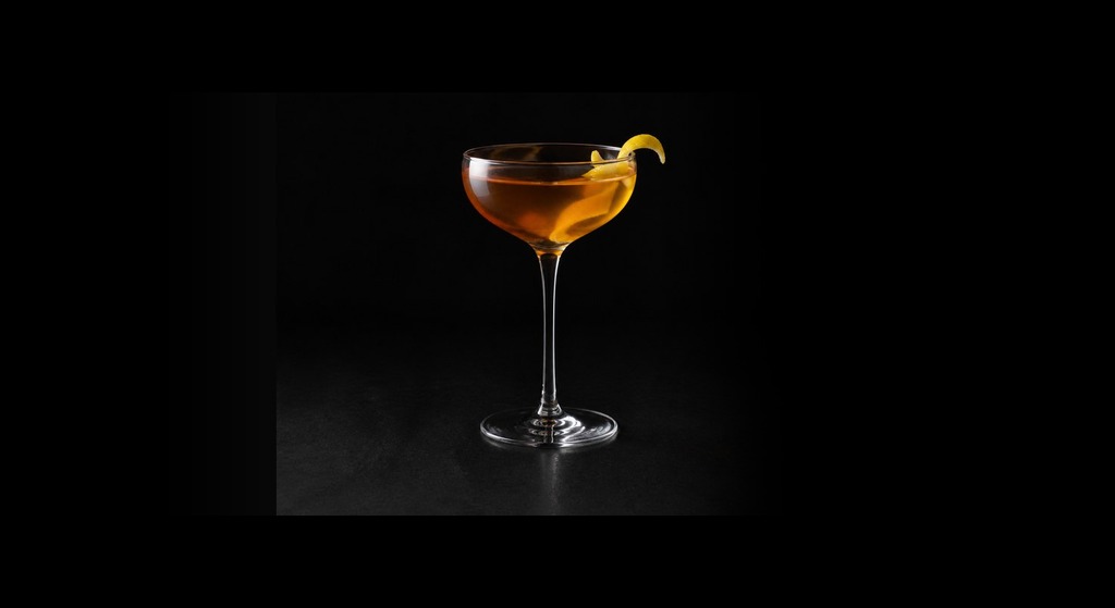 Classic Rob Roy cocktail on a dark studio background