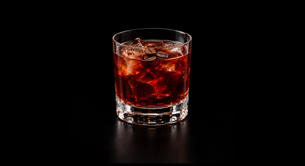 Coffee Negroni cocktail on a dark studio background