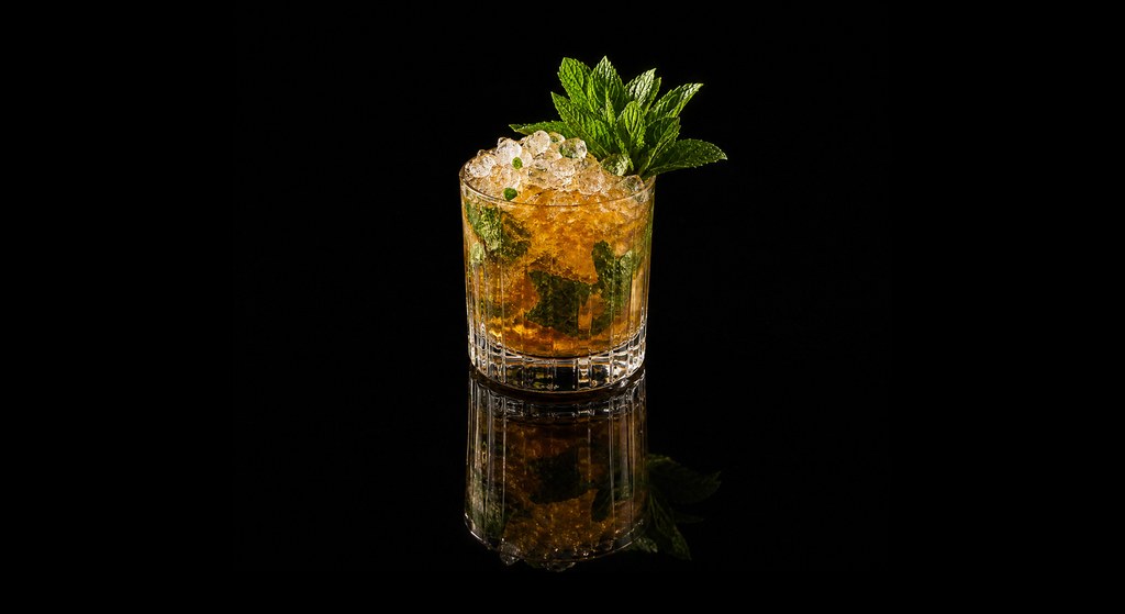 Cognac Julep cocktail on a dark studio background