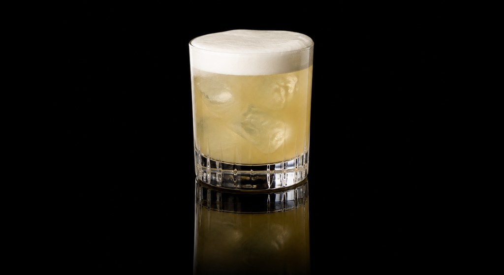 Cold Winter Warmer Sour cocktail on a dark studio background