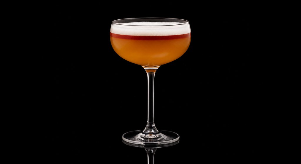 Continental Sour cocktail on a dark studio background