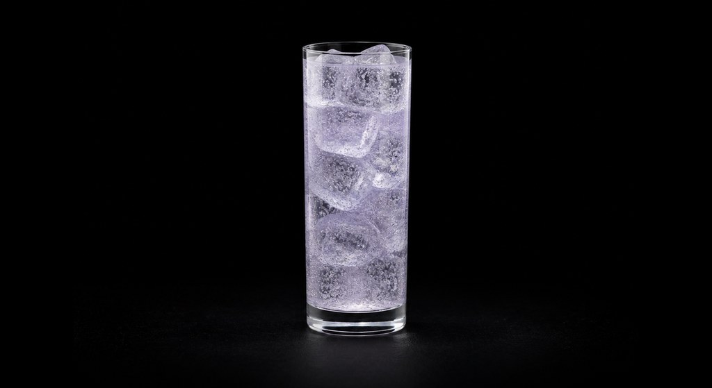 Crème de Canne Collins cocktail on a dark studio background