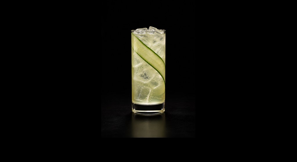 Cucumber Rum Collins cocktail on a dark studio background