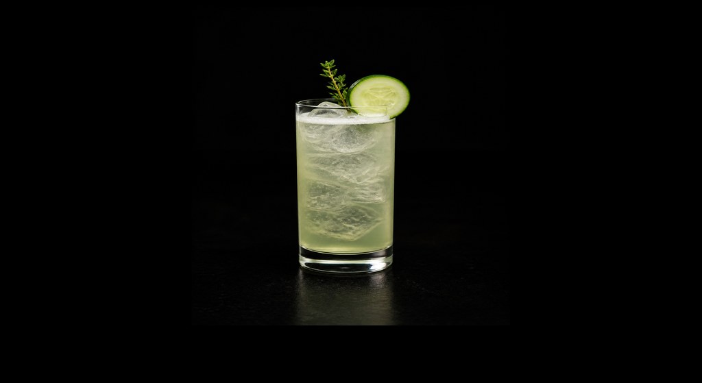 Cucumber Thyme Highball cocktail on a dark studio background