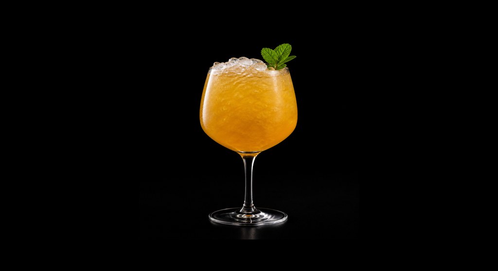 Cure's Vitamin C Cobbler cocktail on a dark studio background