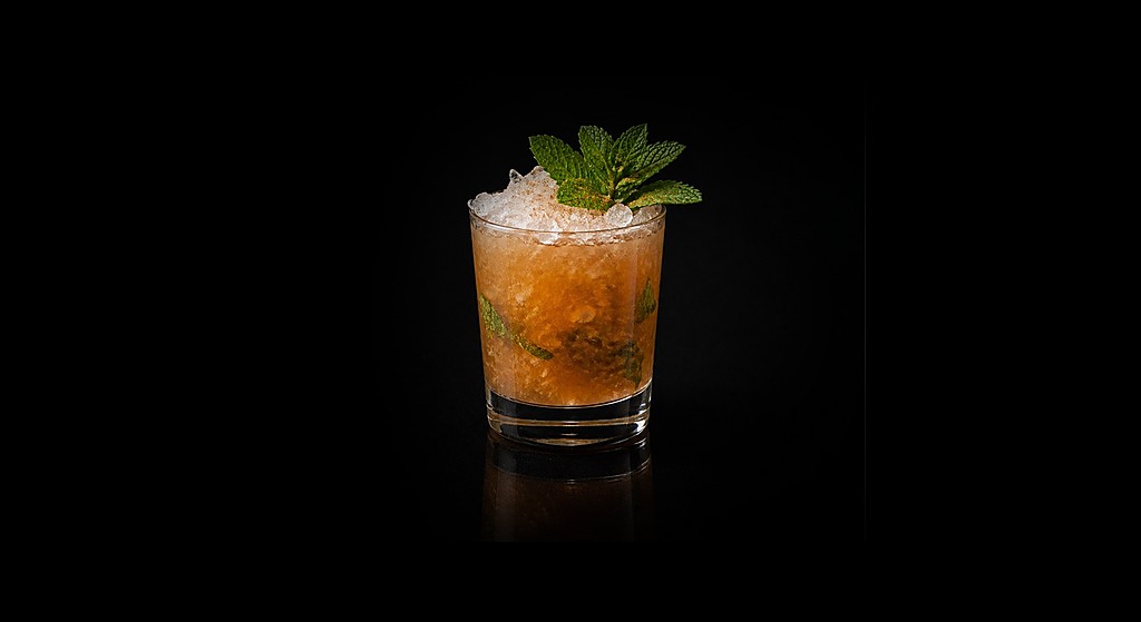 Cynar Julep cocktail on a dark studio background