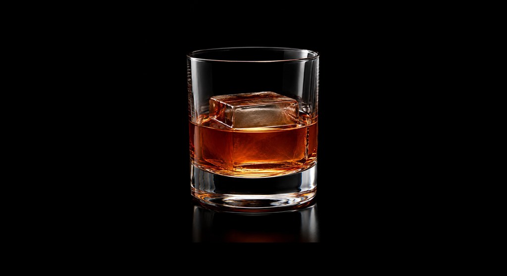 Dante's Old Fashioned Whiskey Cocktail cocktail on a dark studio background