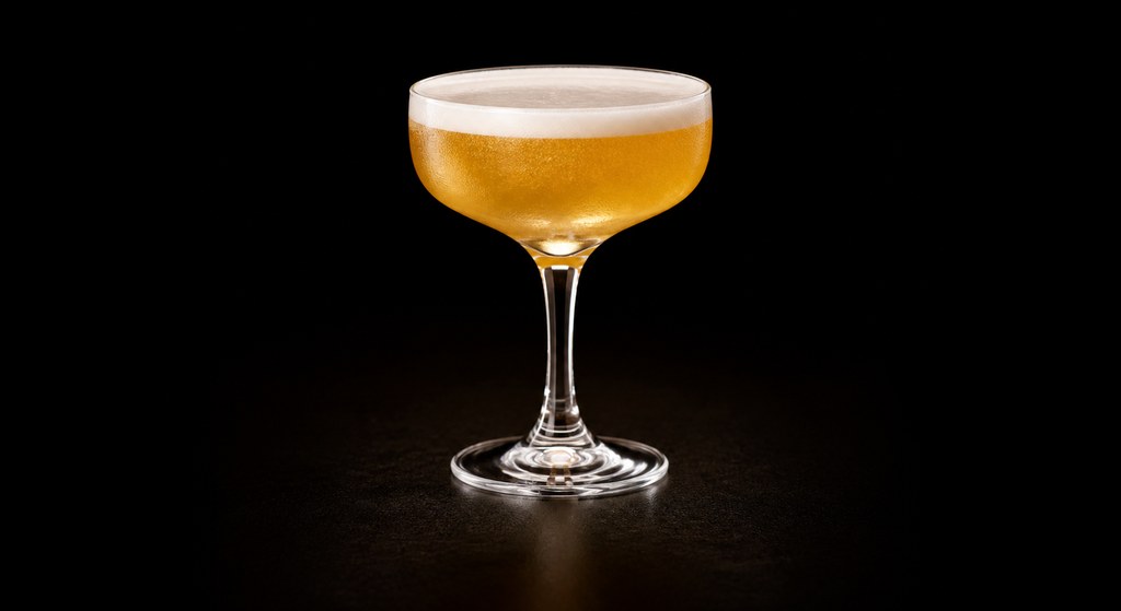 Derby Fizz cocktail on a dark studio background