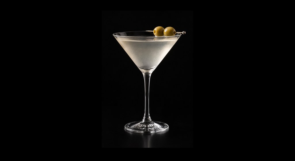 Dirty Martini cocktail on a dark studio background