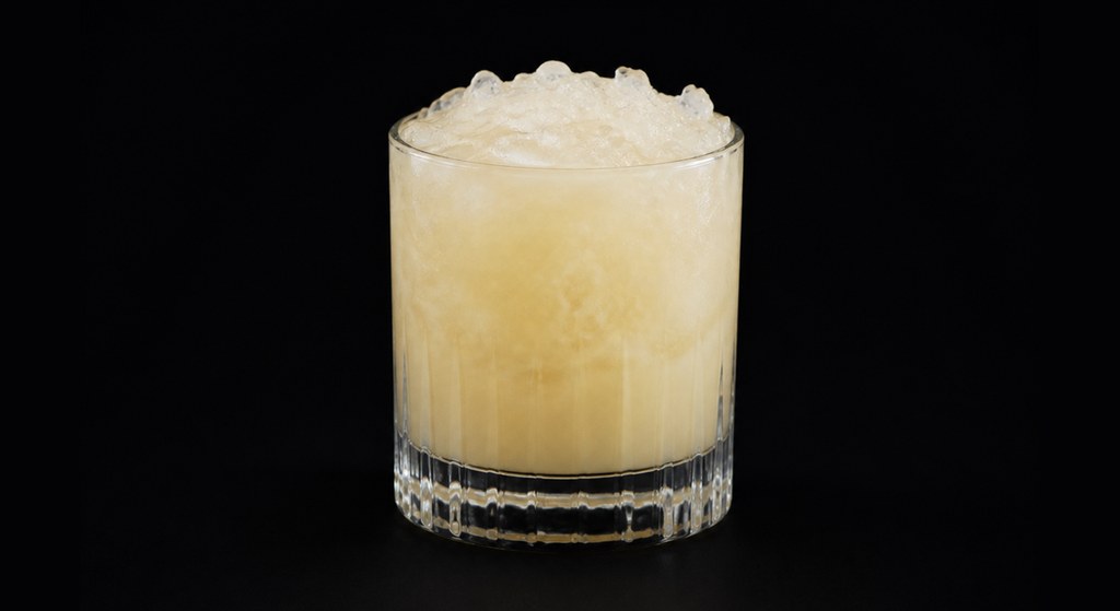 Drunk in the August Sun cocktail on a dark studio background
