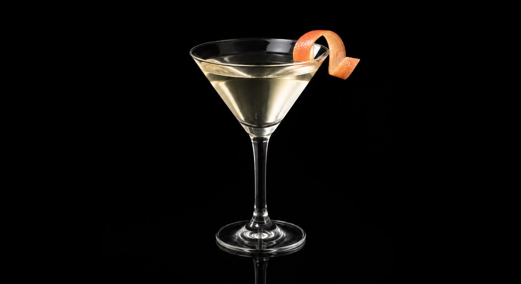 Dry Orange Martini cocktail on a dark studio background