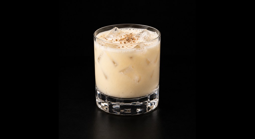 Eggnog cocktail on a dark studio background