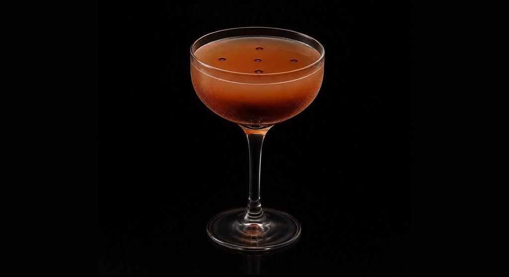 Empellón Cocina's Fat-Washed Mezcal cocktail on a dark studio background
