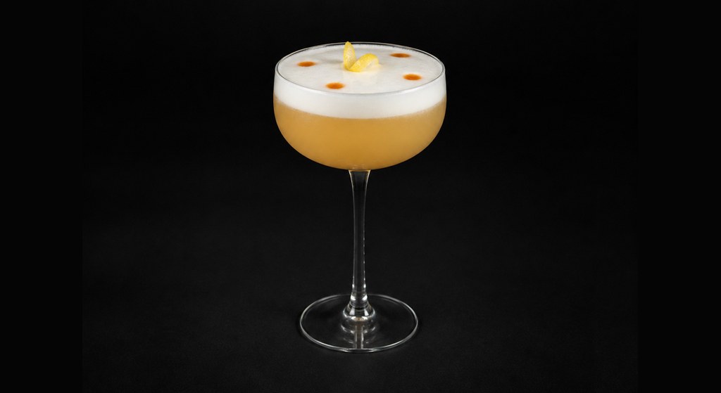 Erik Adkins' Whiskey Sour cocktail on a dark studio background